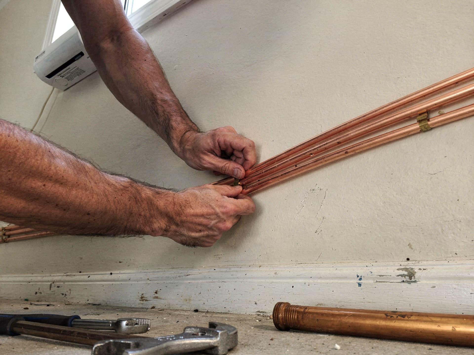 A copper line-set run tight and level on a clean install